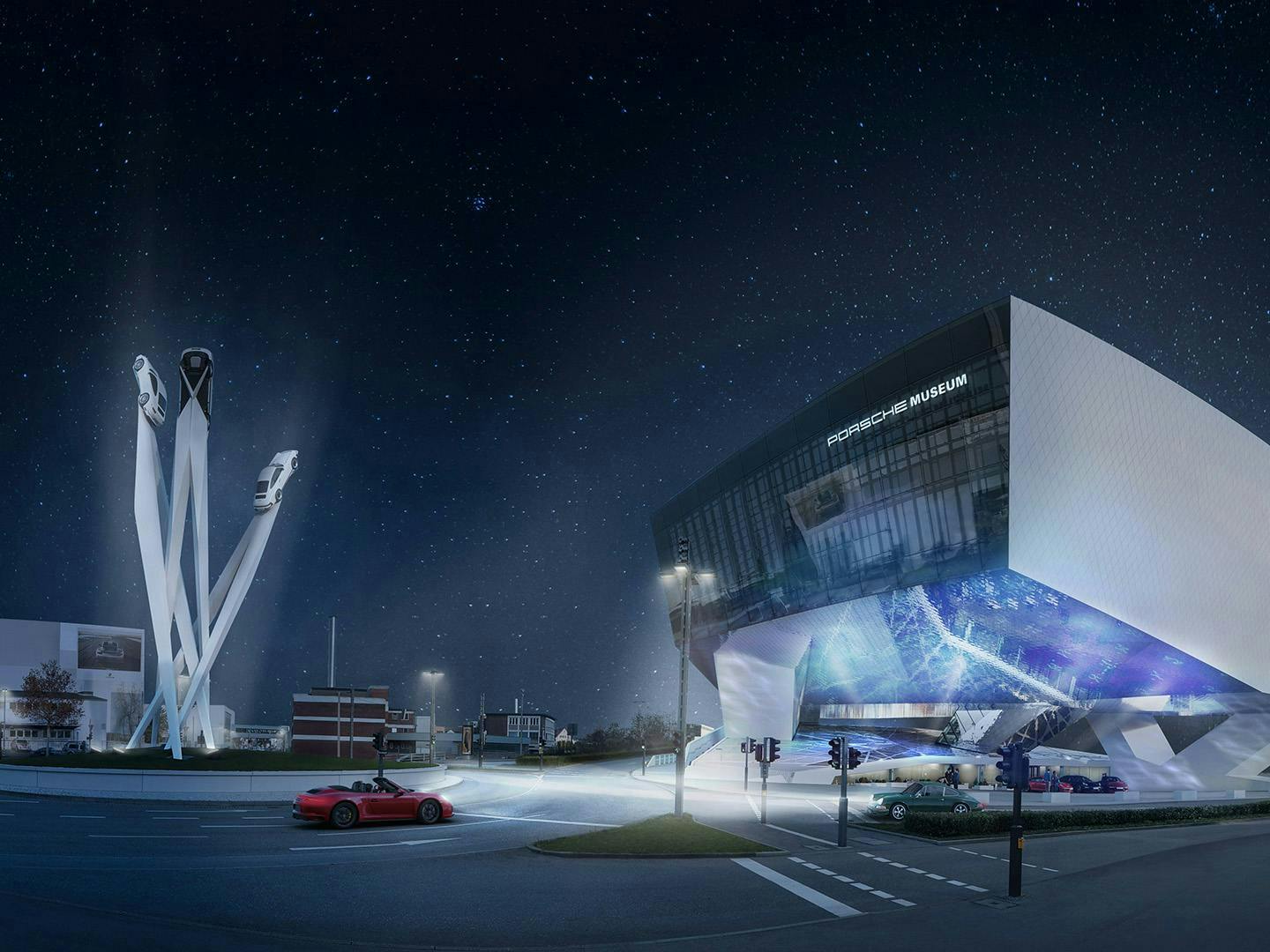 Beleuchtetes Porsche Museum in Stuttgart-Zuffenhausen bei Nacht mit Skulptur am Porscheplatz